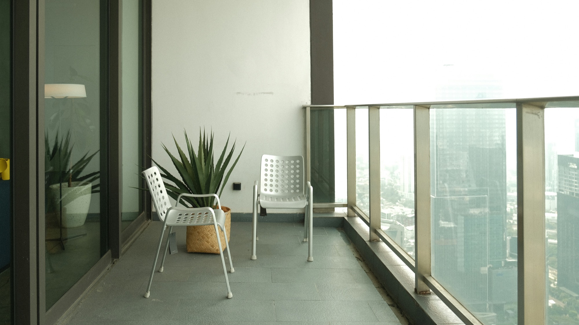 A modern high-rise balcony arranged for everyday use